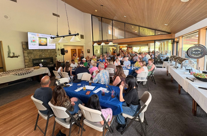 photo of people listening to. a presentation at the sky ball classic